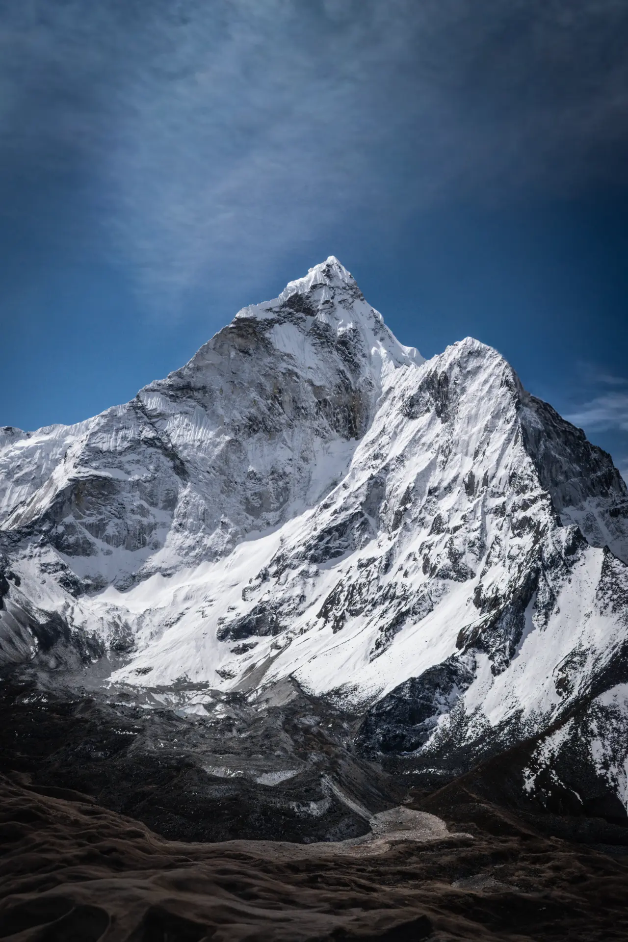 Snow-covered Ama Dablam beneath a deep blue Himalayan sky