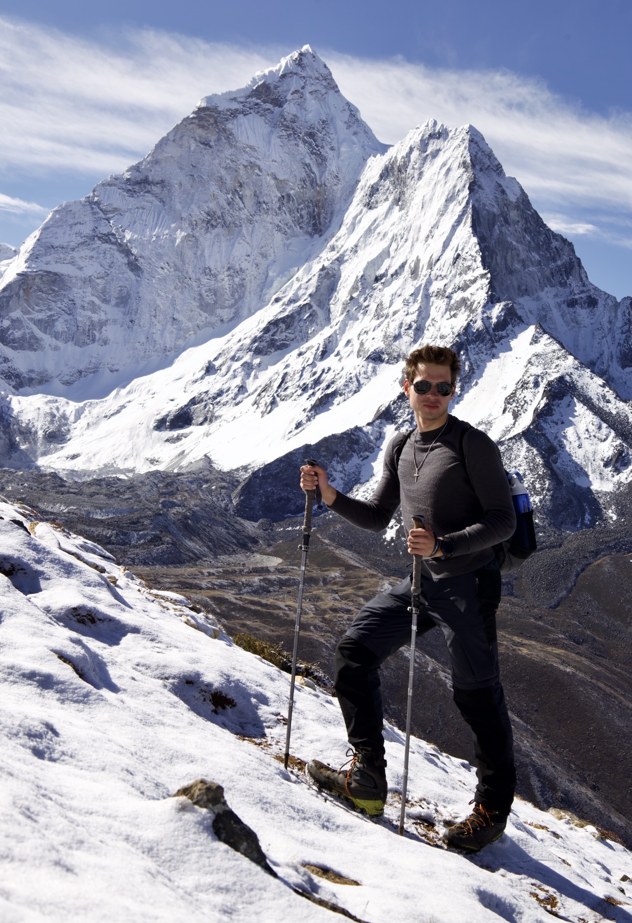 Nick Chaika with trekking poles in front of snow-covered Himalayan peaks